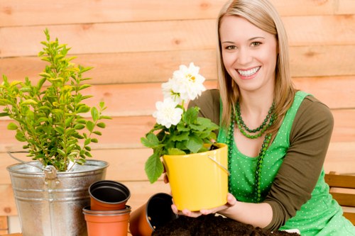Trainer demonstrating safe tool use to gardening staff